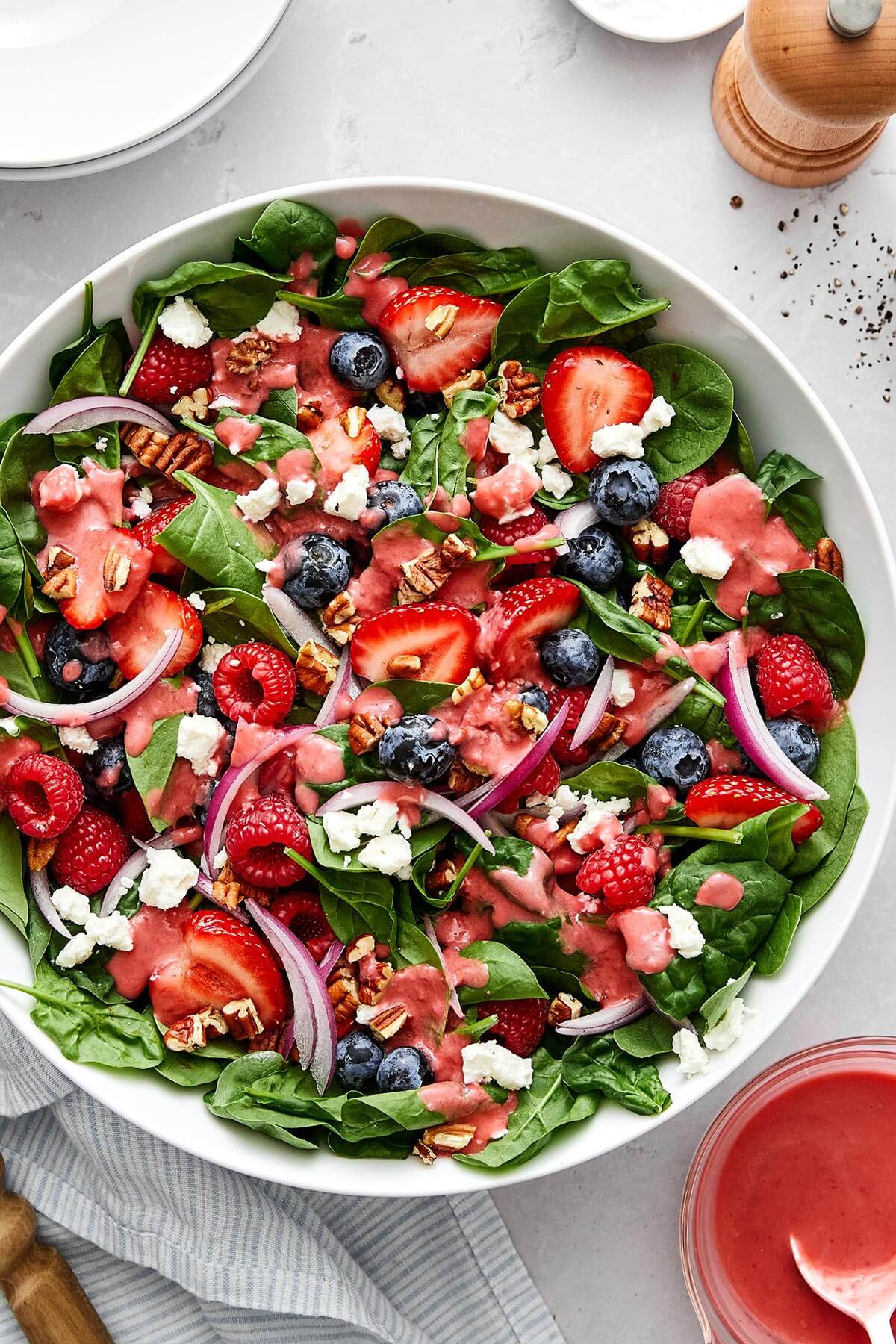 Berry spinach salad in a bowl.