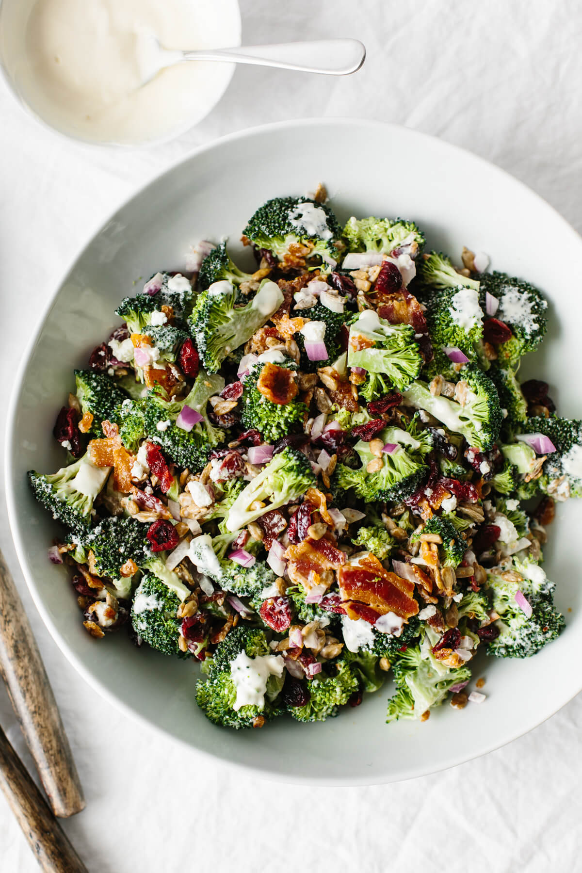 Broccoli salad in a white bowl.