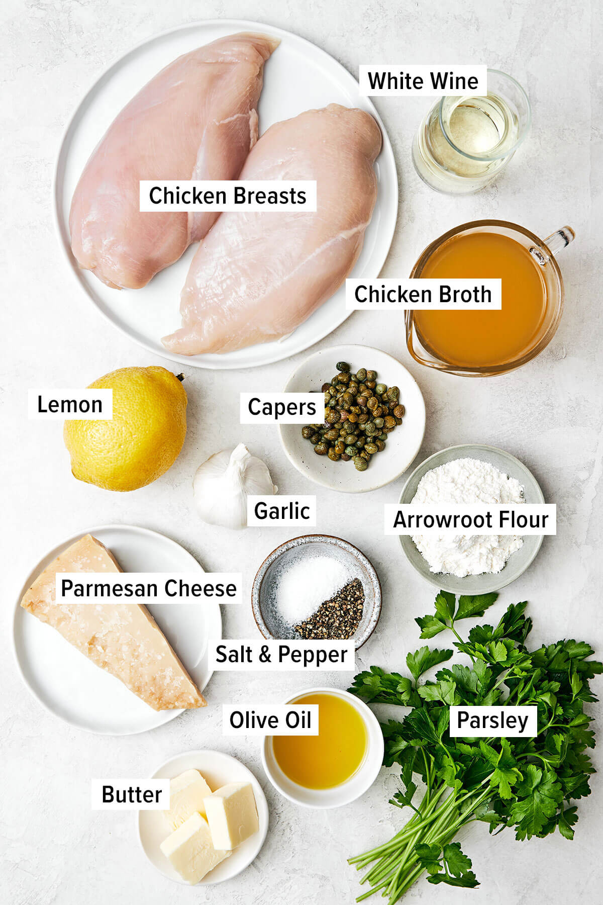Chicken piccata is the best Italian-American dinner made with golden-crusted chicken breasts simmered in a lemon garlic wine sauce. Ingredients for chicken piccata on a table