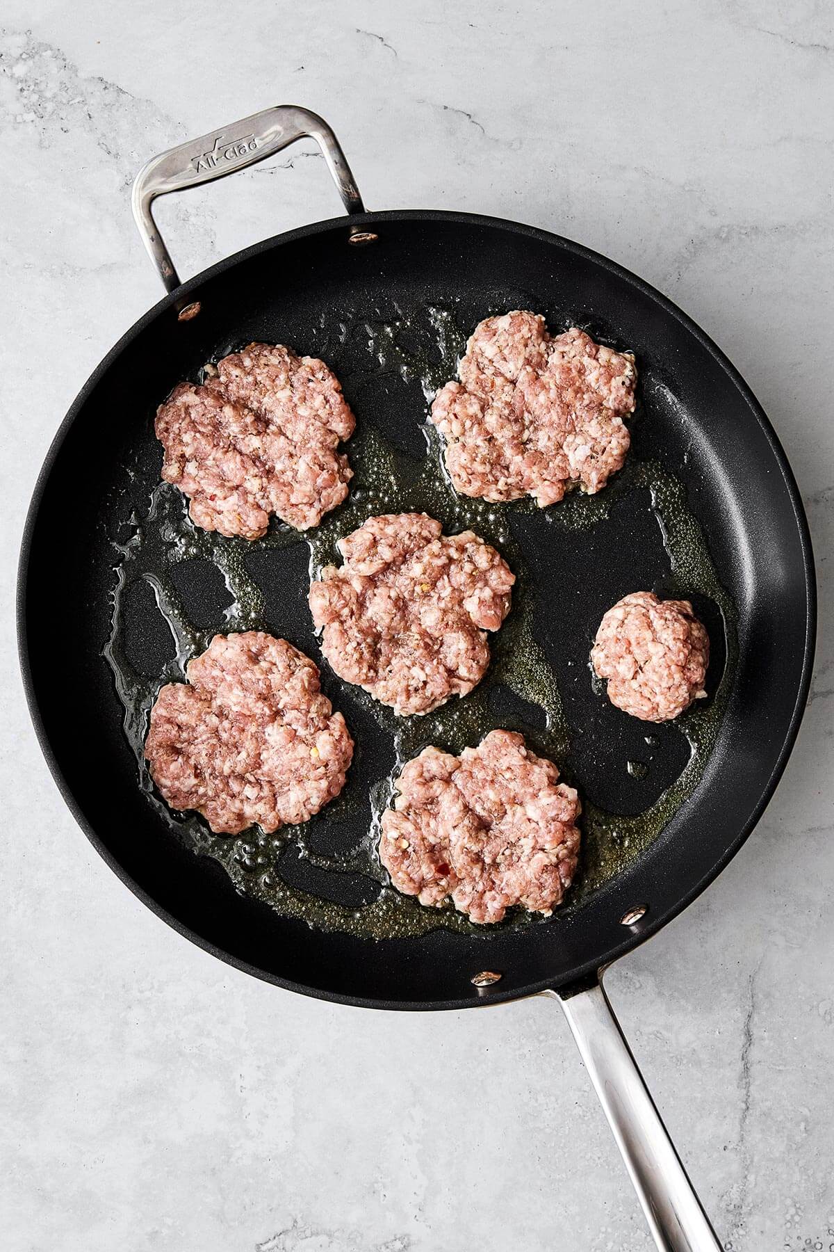Savory and juicy, this homemade breakfast sausage adds a flavorful protein boost to your morning—and it’s way better than store-bought. Cooking breakfast sausages in pan.