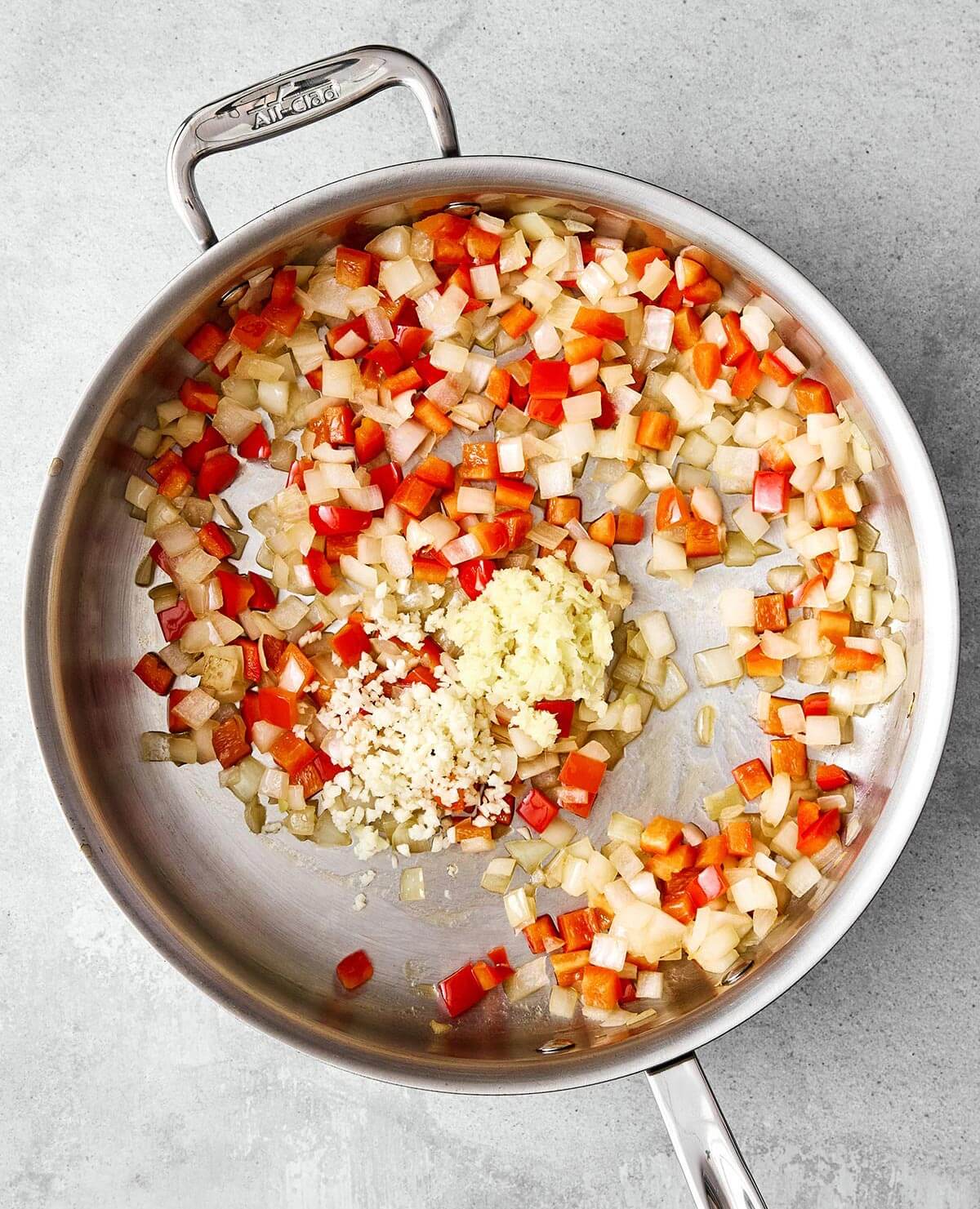 Coconut curry chicken is a cozy one-pan meal that’s packed with comforting flavor. Cooking aromatics in pan.