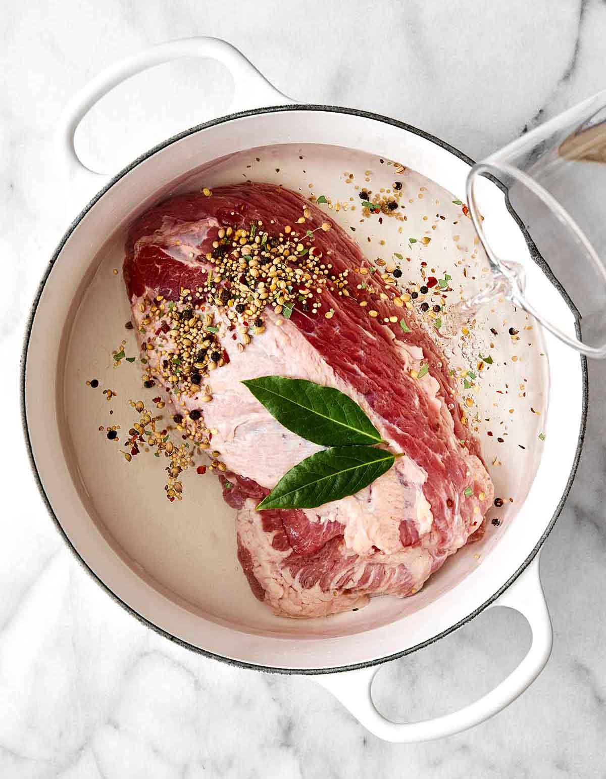Celebrate St. Patrick's Day with the best corned beef and cabbage! Juicy brisket, creamy horseradish sauce, and hearty veggies. Step one of corned beef and cabbage: Cook the meat.