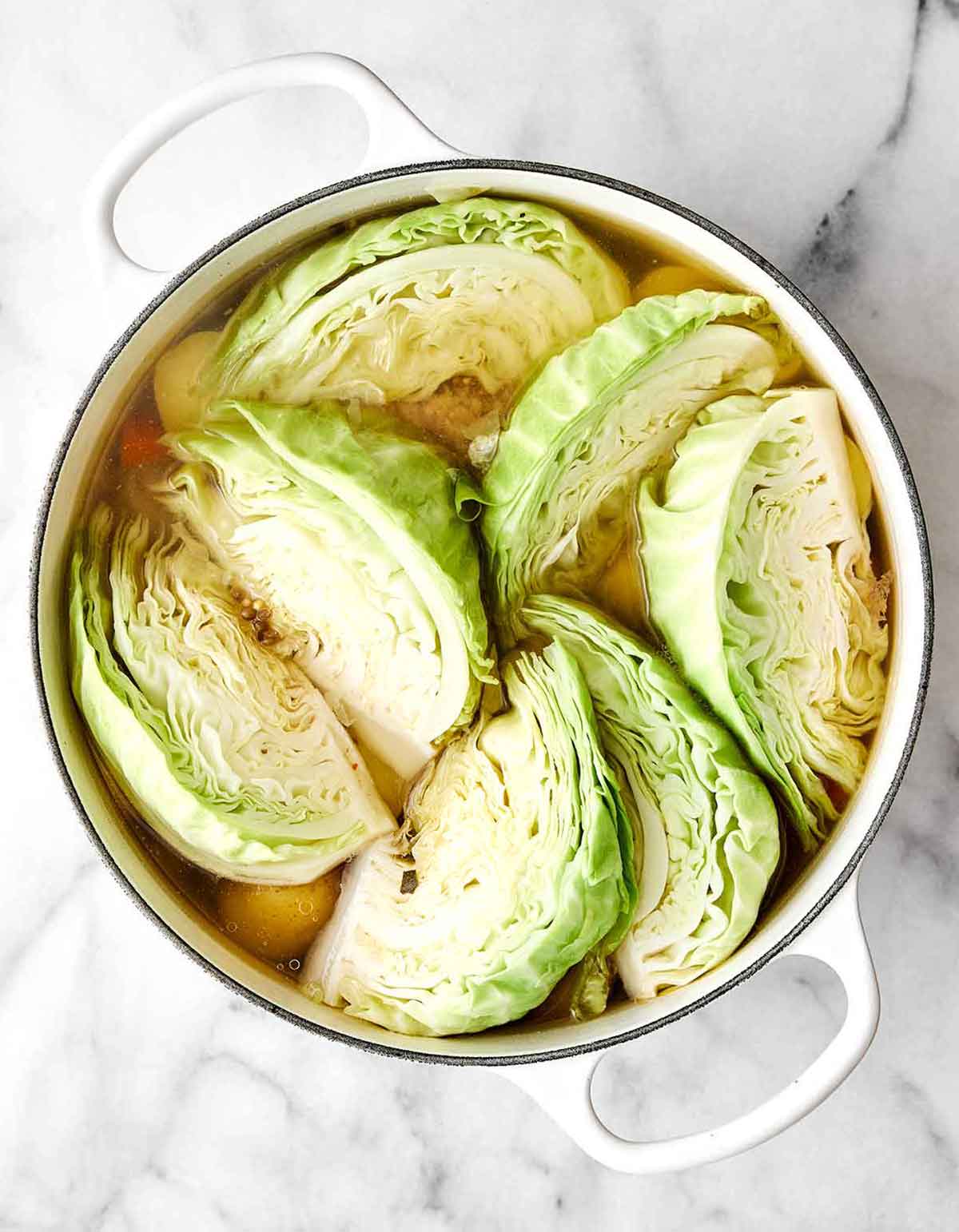 Celebrate St. Patrick's Day with the best corned beef and cabbage! Juicy brisket, creamy horseradish sauce, and hearty veggies. Step three of corned beef and cabbage: Add the cabbage.