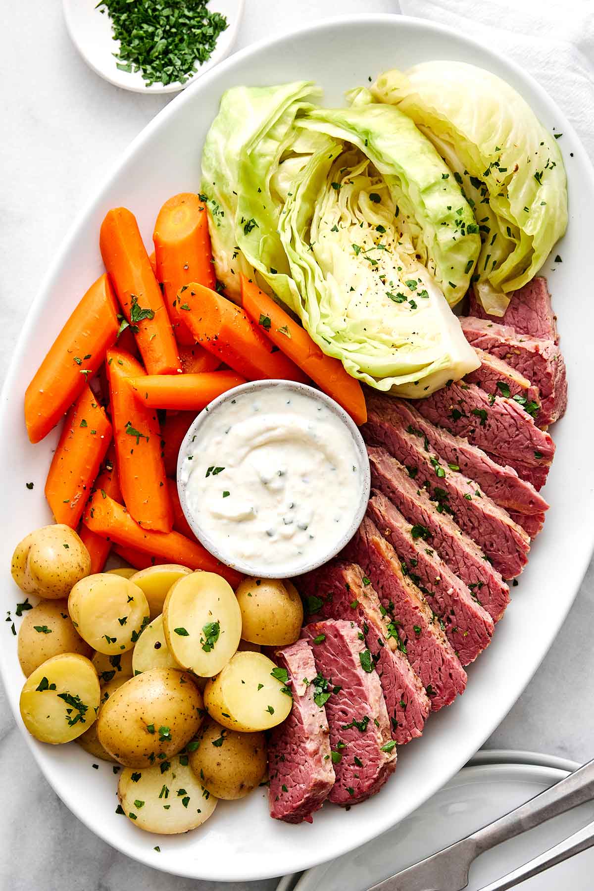 Celebrate St. Patrick's Day with the best corned beef and cabbage! Juicy brisket, creamy horseradish sauce, and hearty veggies. Corned beef and cabbage.