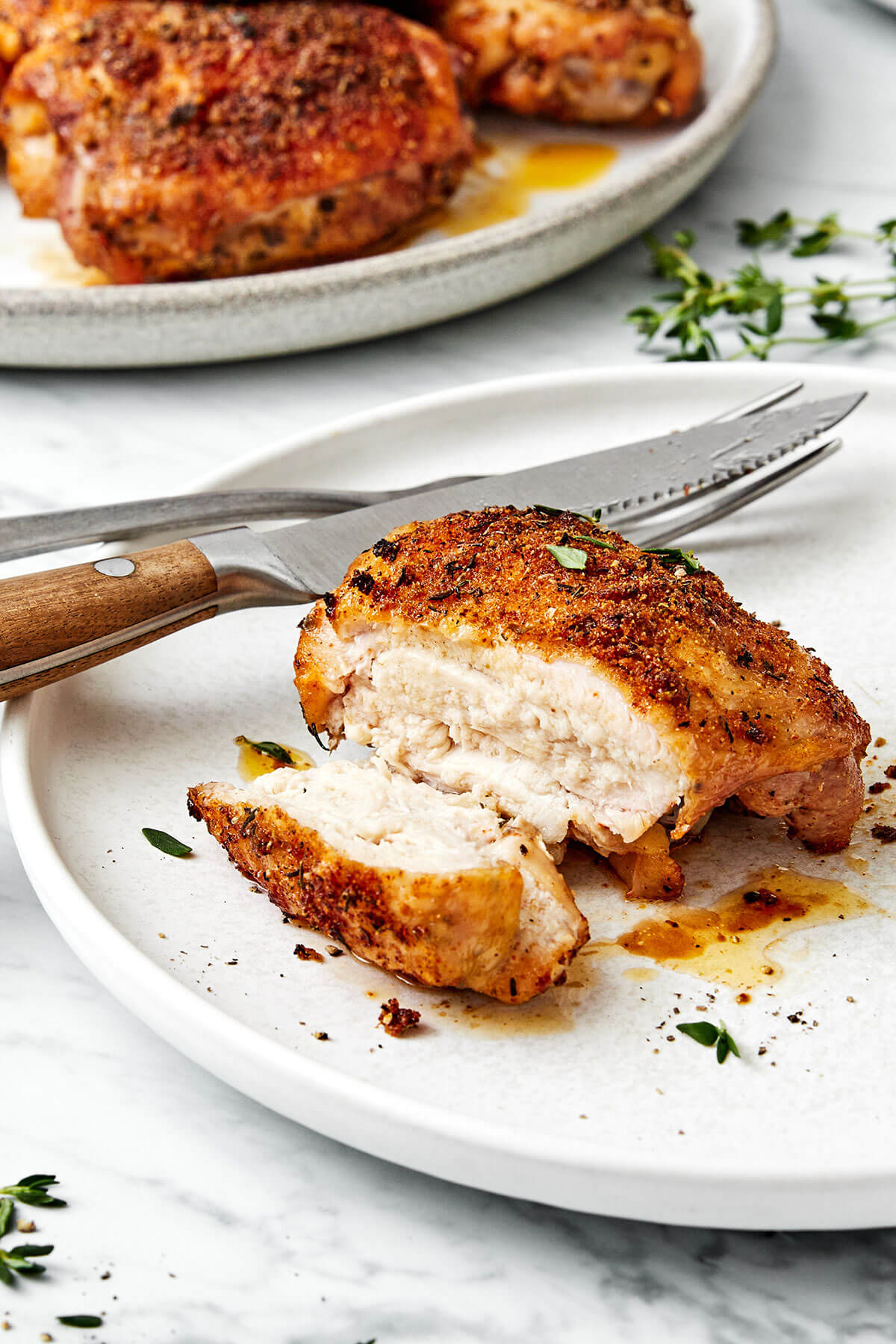 These crispy and juicy baked chicken thighs make for the perfect weeknight meal. They’re incredibly easy to make and packed with flavor! A baked chicken thigh on a plate.