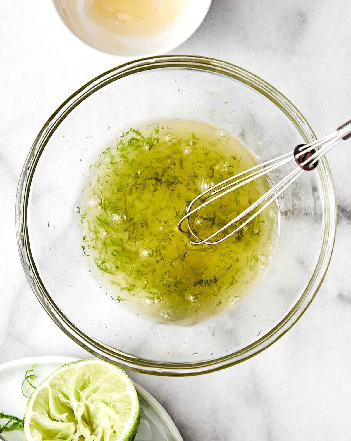 A crowd-favorite fruit salad for BBQs and potlucks! It's incredibly simple with juicy seasonal fruit tossed in a honey lime dressing. Step one of fruit salad: make dressing.