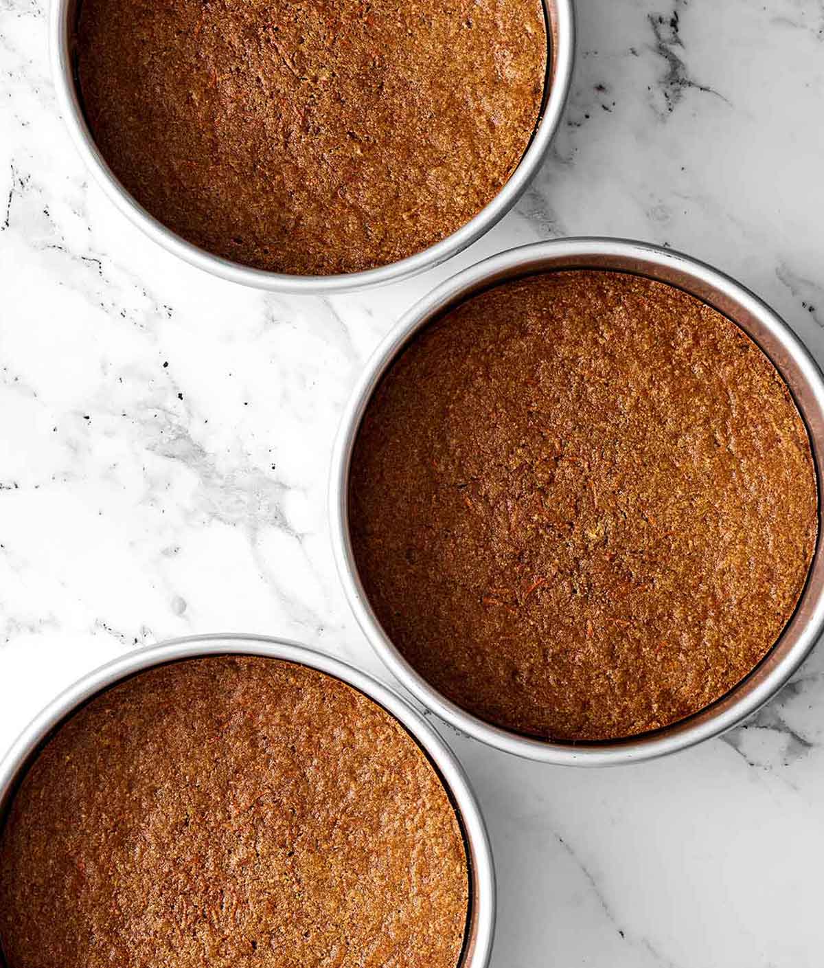 This gluten-free carrot cake has been a reader favorite for years! It’s made with three layers of perfectly spiced carrot cake and just the right amount of cream cheese frosting for a deliciously sweet bite. Step three of gluten-free carrot cake: bake the cake.