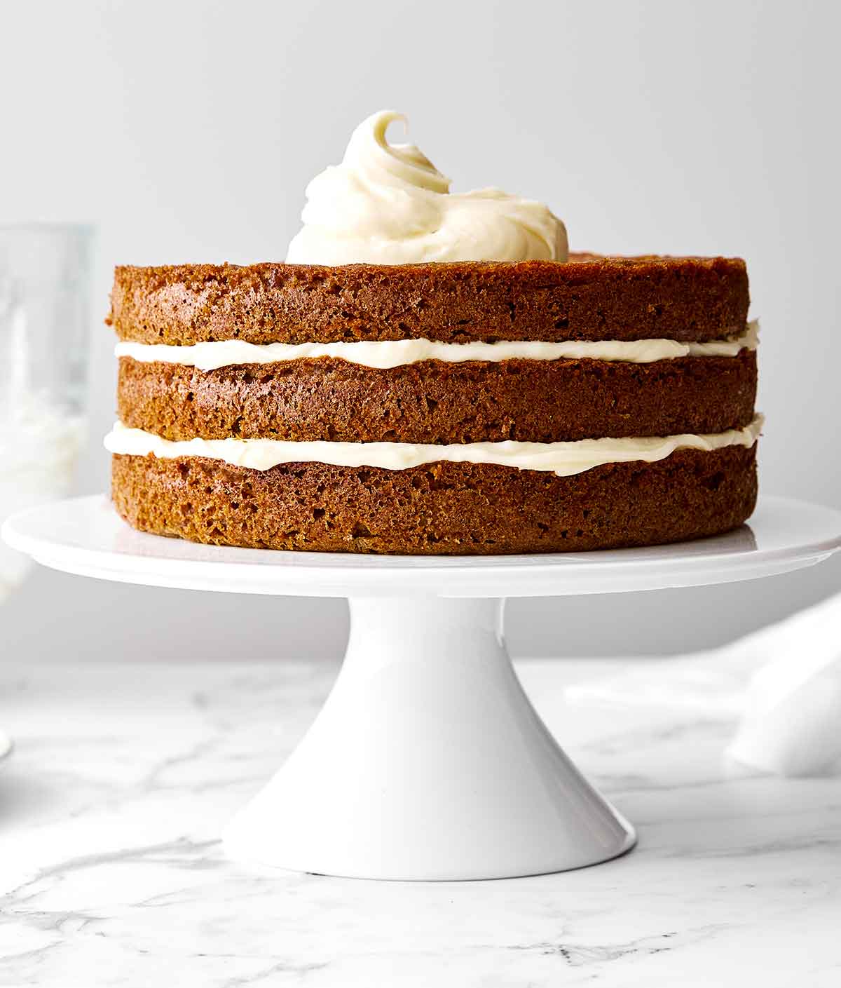 This gluten-free carrot cake has been a reader favorite for years! It’s made with three layers of perfectly spiced carrot cake and just the right amount of cream cheese frosting for a deliciously sweet bite. Step five of carrot cake: Layer the cake.