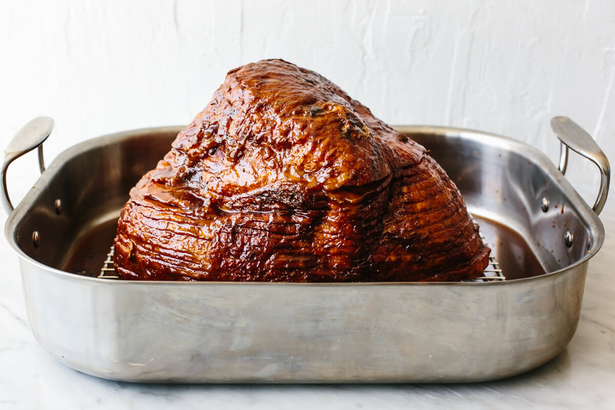 A homemade honey baked ham (with the best honey glaze) that's an easy, foolproof holiday main? We're all for that here! A roasting tray with honey baked ham in it