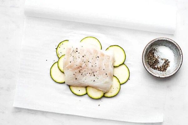 Prepping cod for fish en papillote