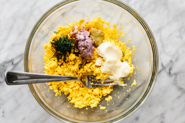Mixing yolk filling for smoked salmon deviled eggs