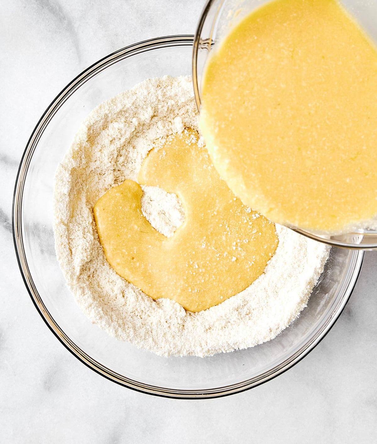 These fluffy lemon ricotta protein pancakes are a sweet and delicious way to incorporate more protein into your breakfast routine! Mixing wet and dry protein pancake ingredients.