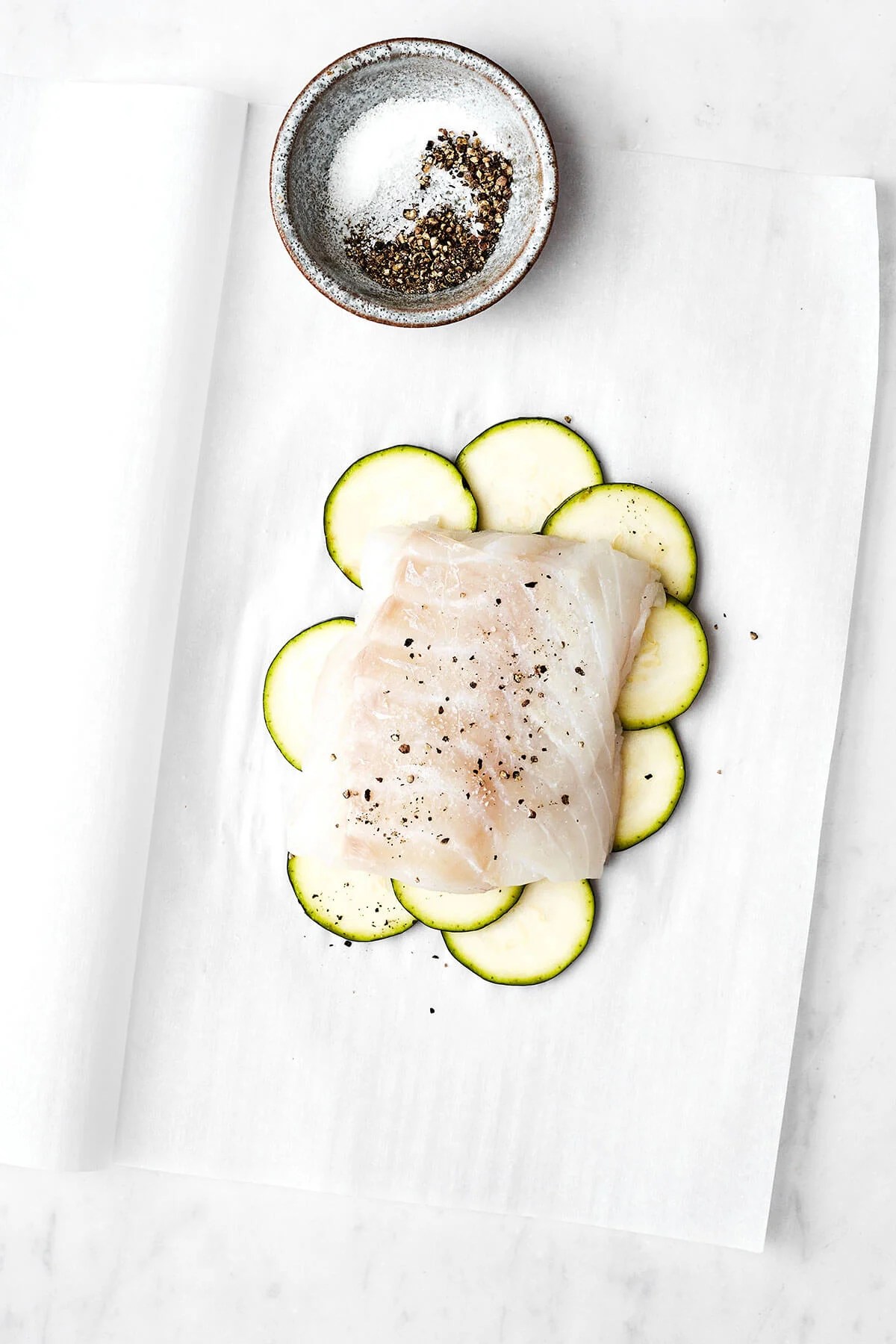 This Mediterranean cod en papillote is the most genius way to quickly achieve a simple, healthy, and super delicious dinner! Initial layers for cod en papillote