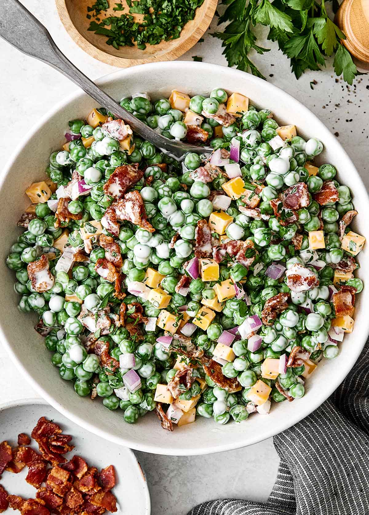 This creamy pea salad has become a spring and summer staple! It's simple, flavorful, and perfect for potlucks and group gatherings. Creamy pea salad.