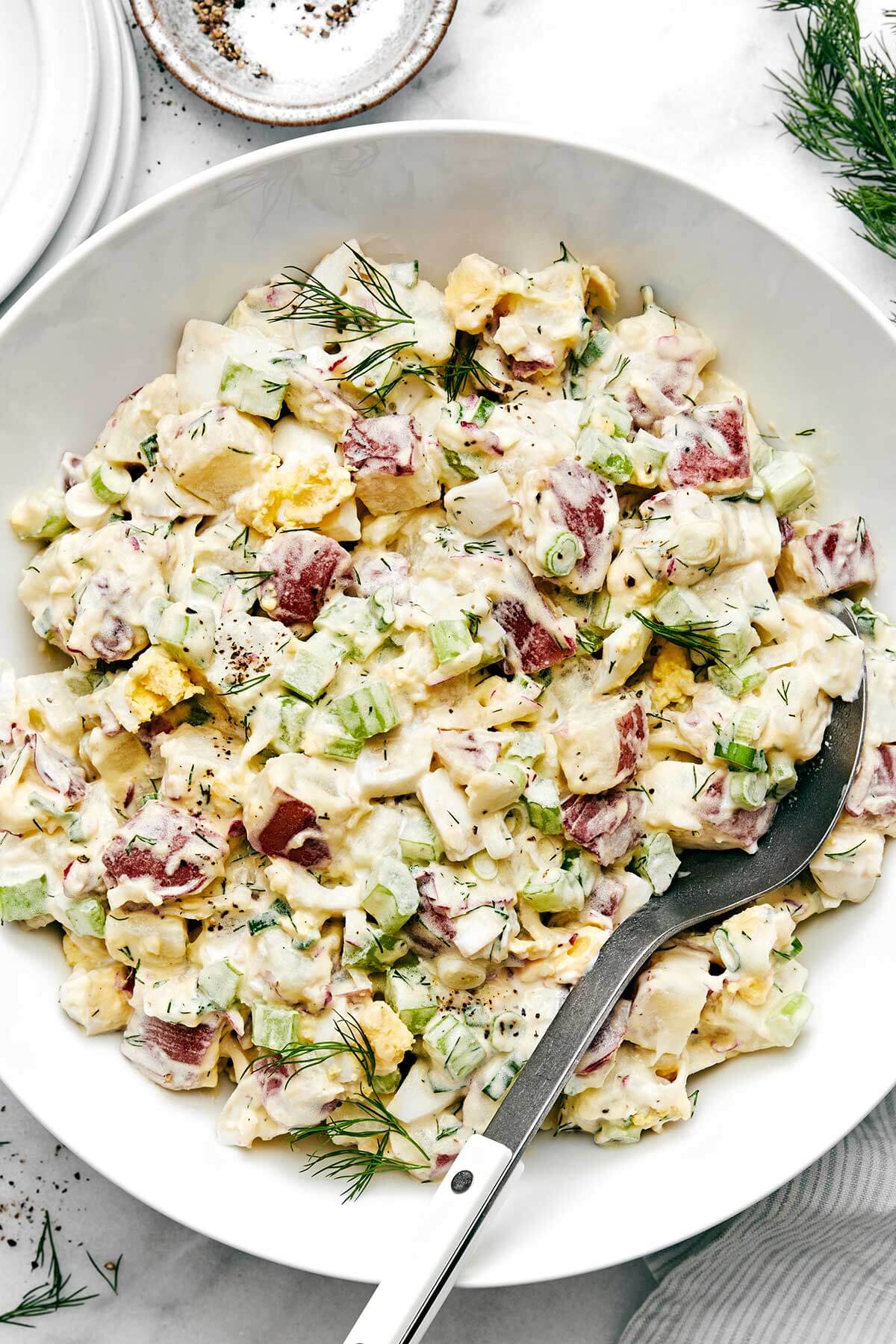 This classic potato salad is easy, flavorful, and loaded with texture. It's the perfect side dish for summer BBQ's, picnics, and dinner parties! A big bowl of classic potato salad.