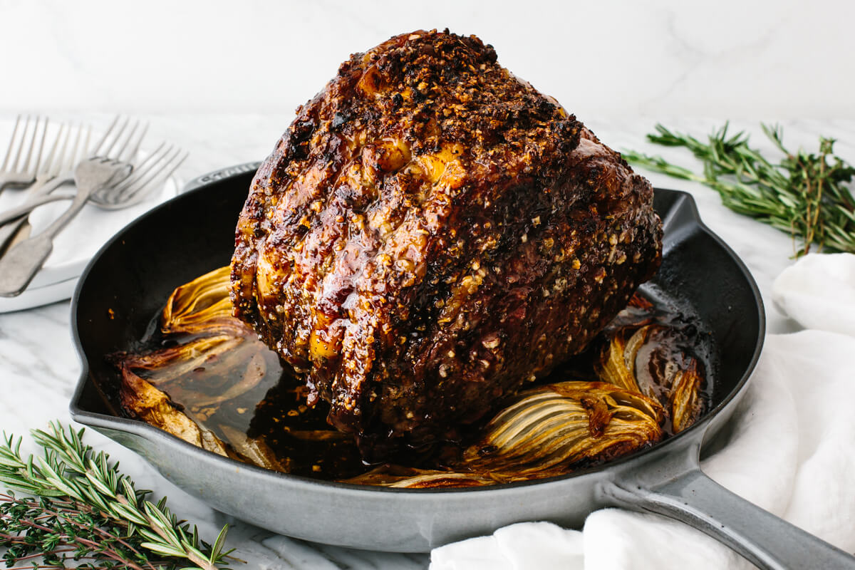 Cooked prime rib in a pan on a table.