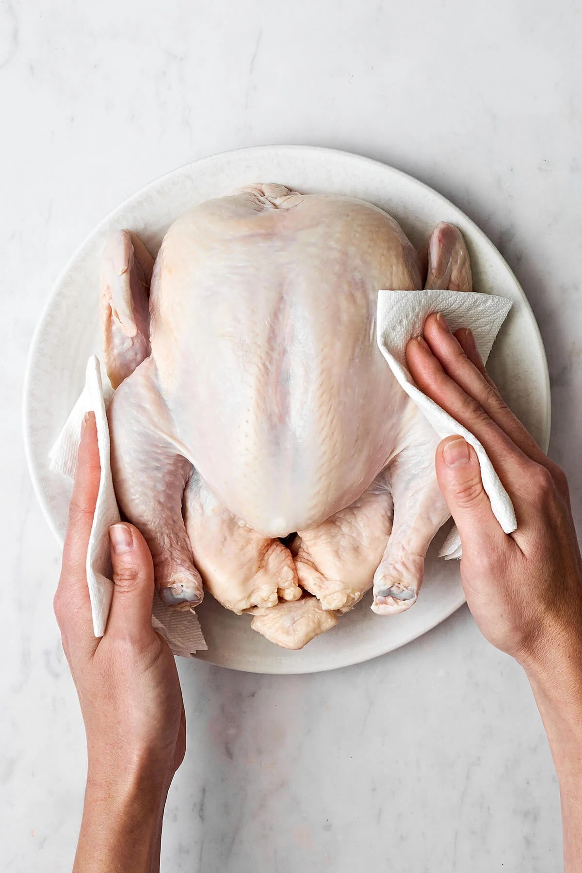 Learning how to roast chicken is the ultimate kitchen staple. It's easy to make, feeds a surplus, and can be served in dozens of ways! Patting a whole chicken dry before roasting