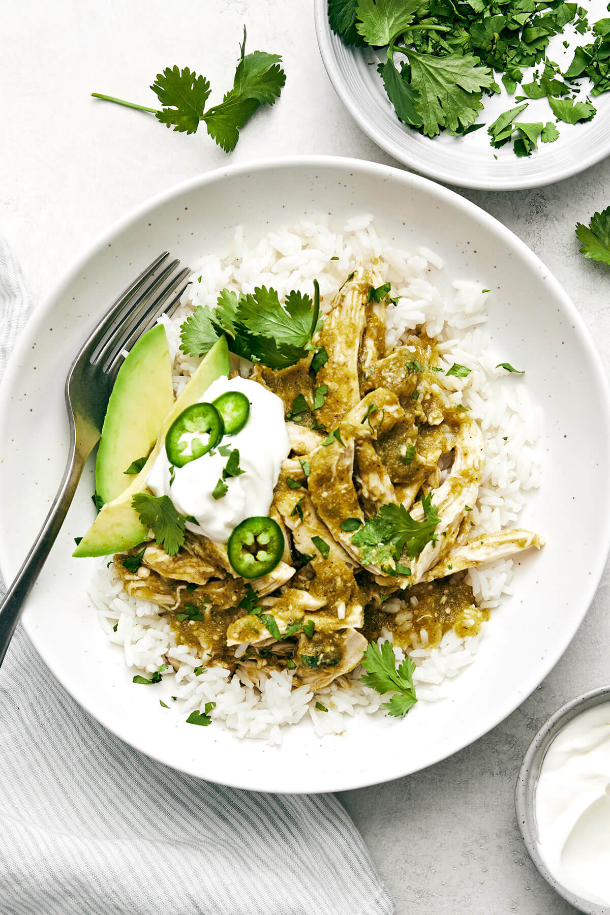 This salsa verde chicken is juicy, tender, and brimming with smoked, tangy, and spicy flavors. Plus, it's made easy right in the slow cooker! Slow cooker salsa verde chicken with rice.