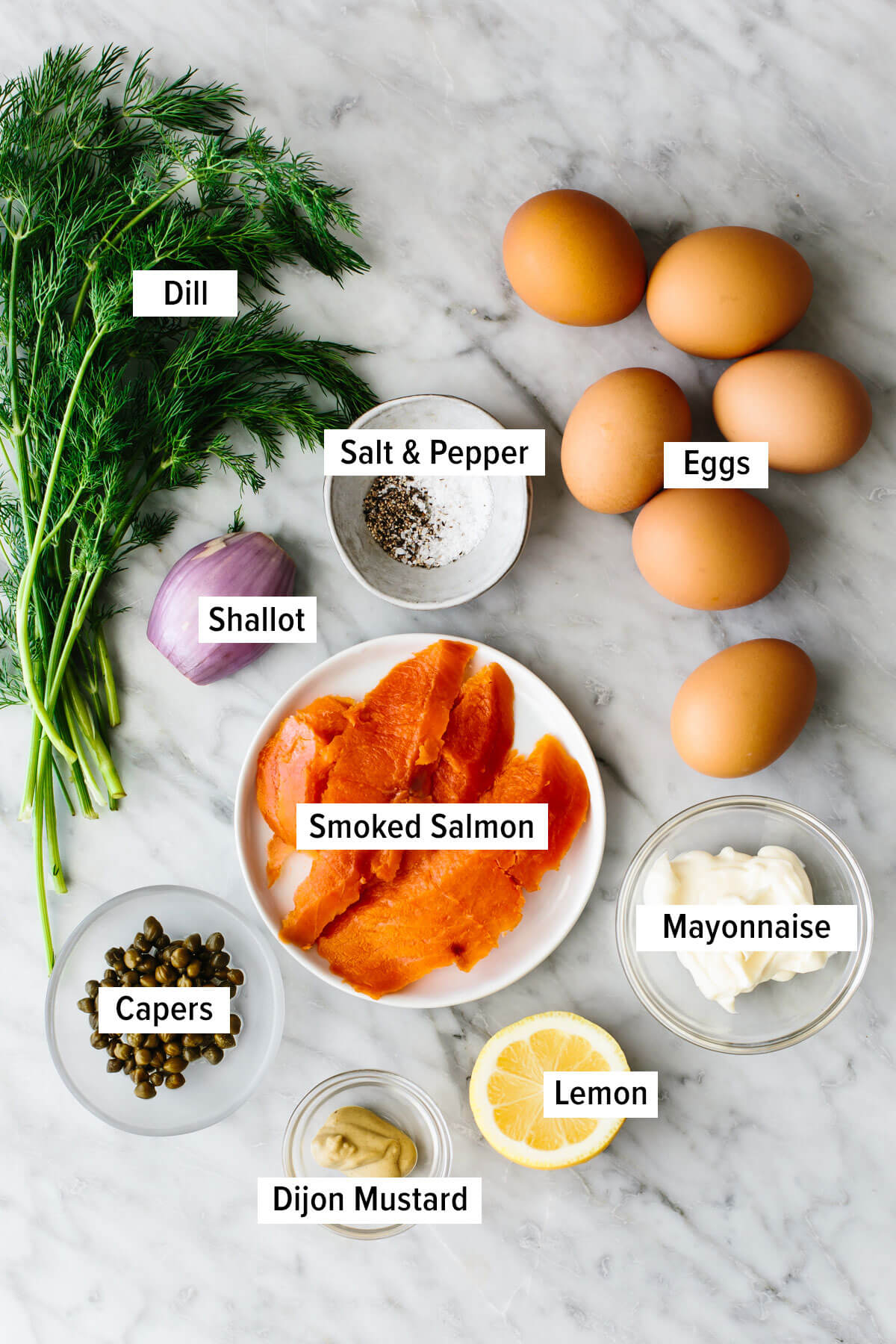 Smoked salmon deviled eggs takes this timeless appetizer to a whole other level. It's got fresh seaside vibes, tons of flavor, and looks extra pretty on a platter! Ingredients for smoked salmon deviled eggs on a table.