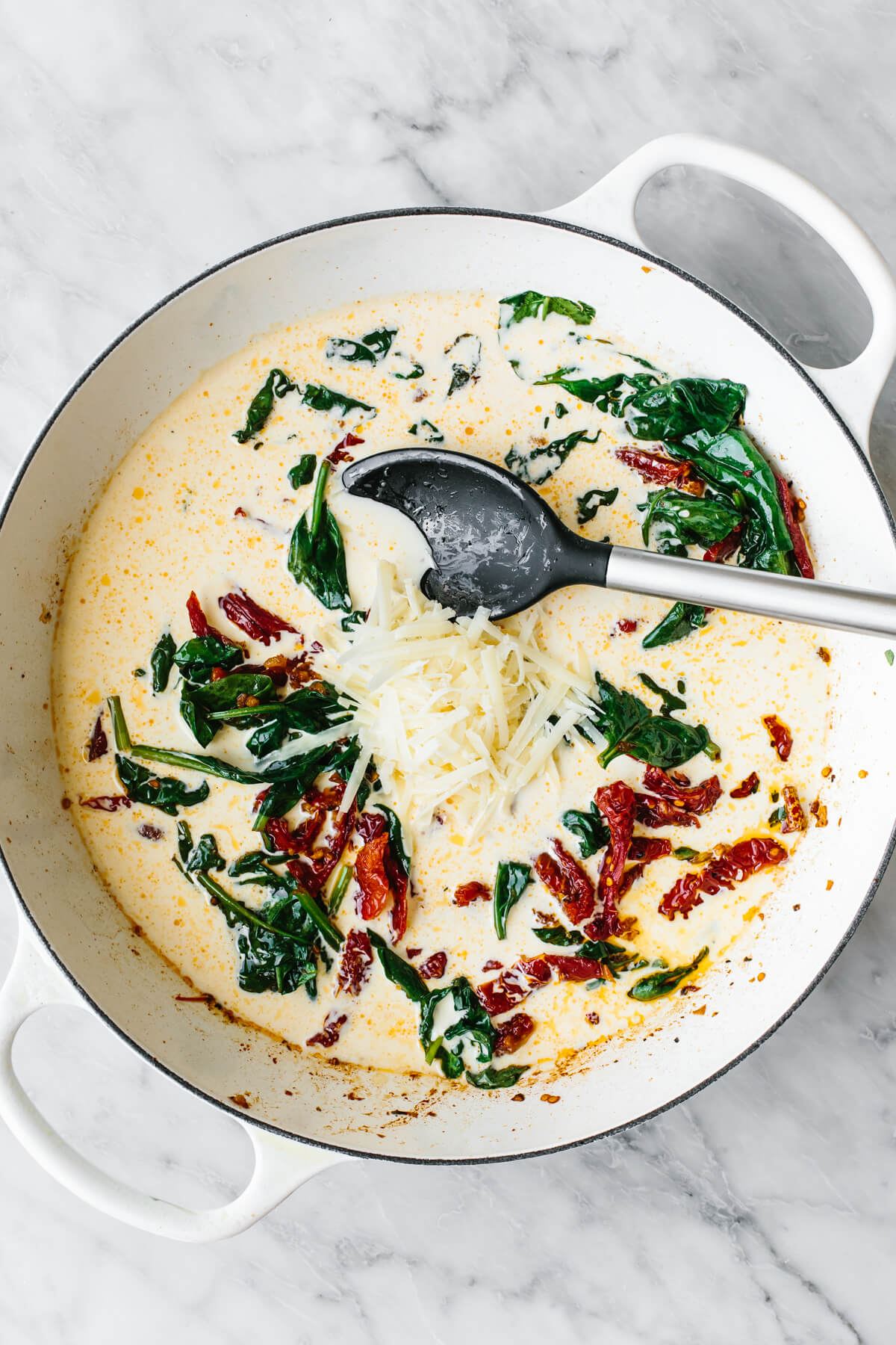 Steal hearts with this creamy tuscan chicken recipe! Seared Italian chicken simmers in a rich and creamy, spinach and sun-dried tomato sauce. Adding cream into a pan for tuscan chicken