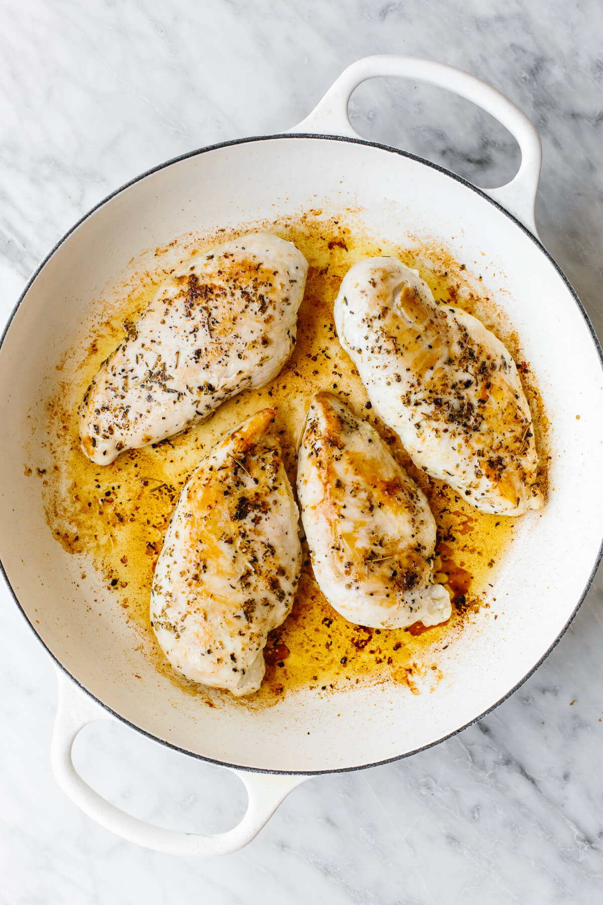 Steal hearts with this creamy tuscan chicken recipe! Seared Italian chicken simmers in a rich and creamy, spinach and sun-dried tomato sauce. Cooking chicken breasts in a skillet for tuscan chicken